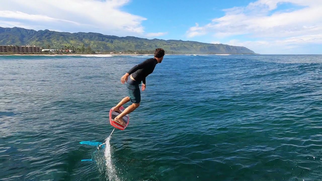 Expert surfer riding waves on a foil board